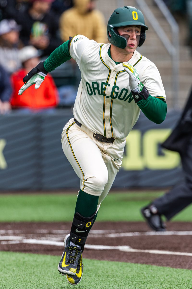 University of Oregon catcher Burke-Lee Mabeus (5) sprints down the baseline after making contact. The University of Oregon baseball team defeated Columbia University 7-0 on Mar. 2, 2025 at PK Park in Eugene, Ore. (Max Unkrich / Emerald)