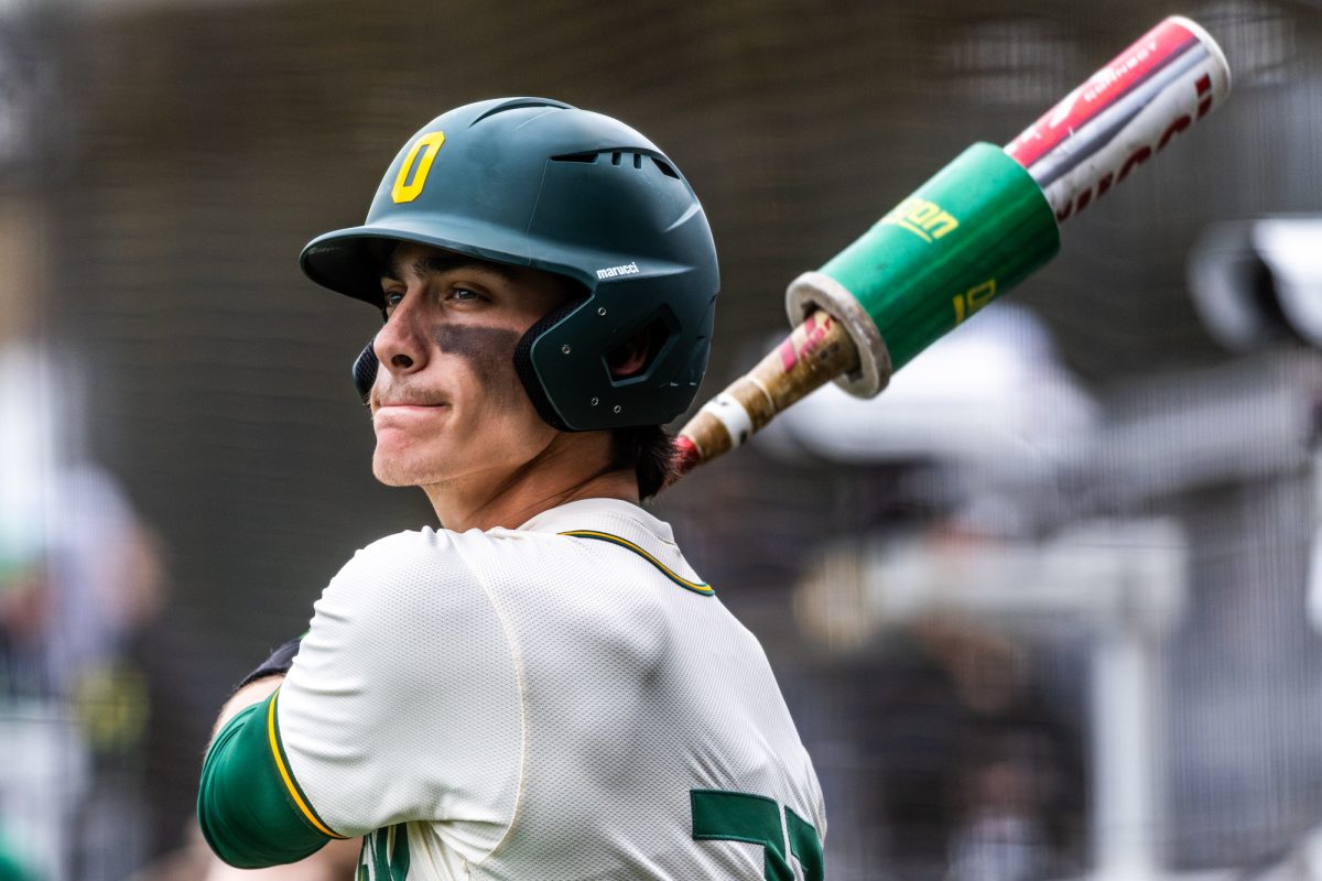 University of Oregon catcher Anson Aroz (77) focuses as he takes his warm-up swings before stepping up to the plate. The University of Oregon baseball team defeated Columbia University 7-0 on Mar. 2, 2025 at PK Park in Eugene, Ore. (Max Unkrich / Emerald)