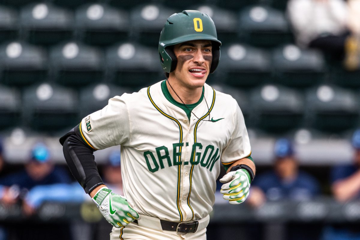 University of Oregon catcher Anson Aroz (77) jogs back to the dugout with a smile after crossing home plate. The University of Oregon baseball team defeated Columbia University 7-0 on Mar. 2, 2025 at PK Park in Eugene, Ore. (Max Unkrich / Emerald)