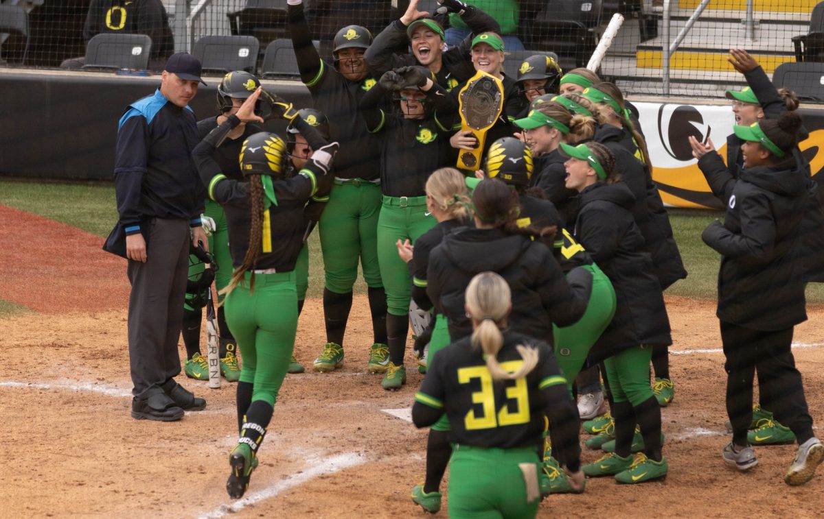 Oregon outfielder Kedre Luschar (1) is cheered on by her team after hitting a grand slam. The University of Oregon Ducks defeated the Loyola Chicago Ramblers 9-1 on March 2, 2025, at Jane Sanders Stadium. The Ducks Will next play the Flordia State Seminoles on March 8. (Miles Cull/Emerald)