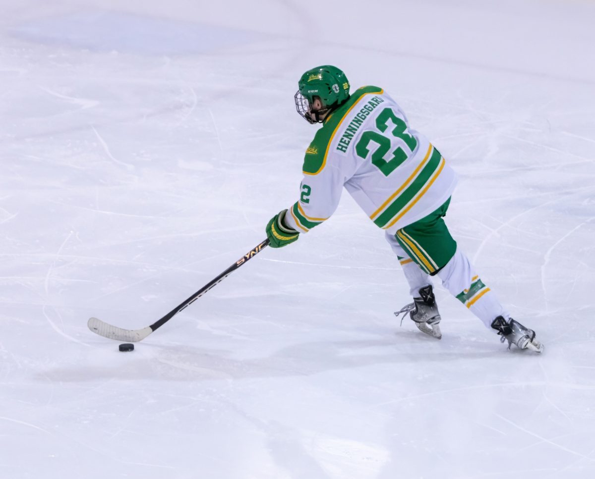 Oregon forward Jackson Henningsgard (22) takes the puck up the ice towards goal. The University of Oregon Hockey team went up against the Rogue Valley Royals for Senior Night, and for the final game of the season March 1, 2025, at The Rink Exchange in Eugene, Ore. Ducks defeated the Royals 6-2. (Anna Liv Myklebust / Emerald)