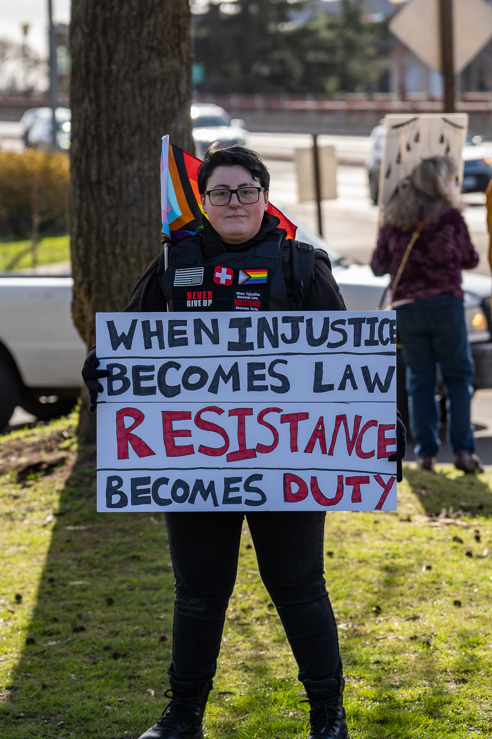 Sharon Silva, a protestor at the March 4 America rally, holds a sign that says "When Injustice Becomes Law Resistance Becomes Duty". The March 4 America rally was held in front of the Eugene City Hall from 12 p.m. to 4 p.m. on Mar 4, 2025 in Eugene, Ore. (Saj Sundaram/Emerald)