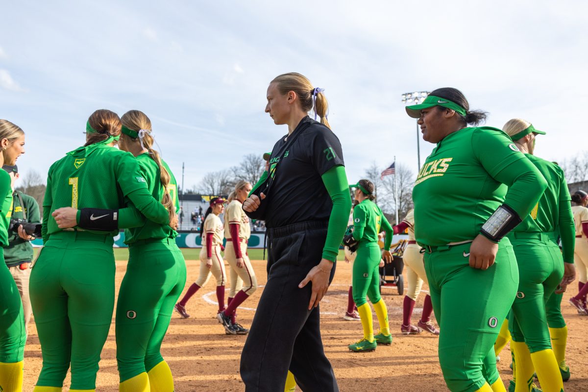 Emma Cox (21) joins her team on the field after the Ducks win. The Oregon Ducks softball team faces off against the Florida State Seminoles in the Jane Saunders Classic at Jane Saunders Stadium in Eugene, Ore, on Mar. 9, 2025. (Molly McPherson/Emerald)