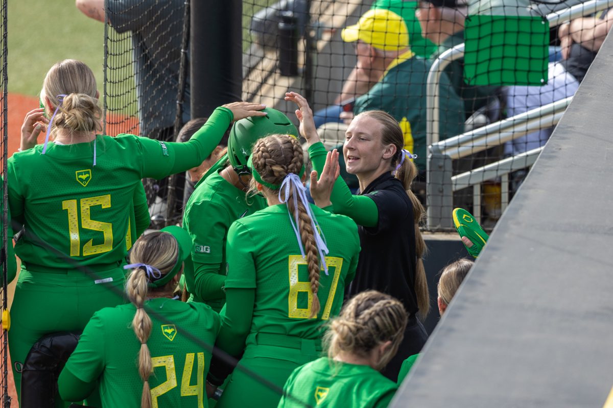 Emma Cox (21) cheers with her team in the Oregon Dugout. The Oregon Ducks softball team faces off against the Florida State Seminoles in the Jane Saunders Classic at Jane Saunders Stadium in Eugene, Ore, on Mar. 9, 2025. (Molly McPherson/Emerald)