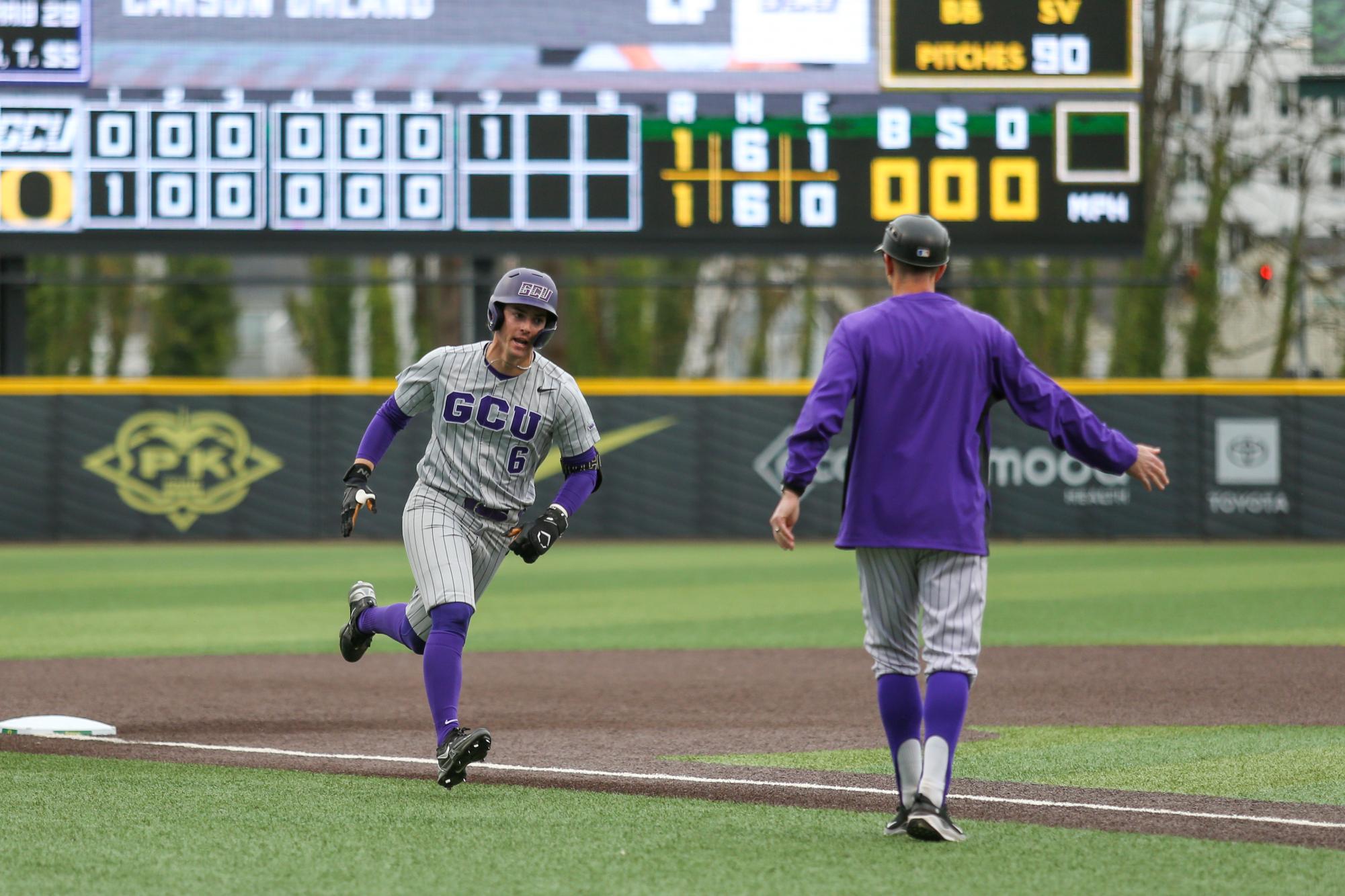 Carson Ohland (6) celebrates a home run with his third base coach. Oregon Baseball takes on Grand Canyon in Eugene, Ore. on Mar. 11, 2025.