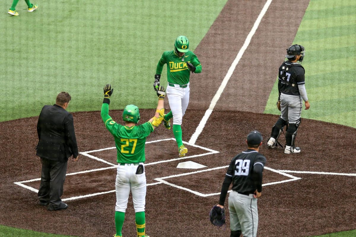 Mason Neville (center) crosses home. Oregon Baseball faces Grand Canyon in Eugene, Ore. on Mar. 12, 2025.