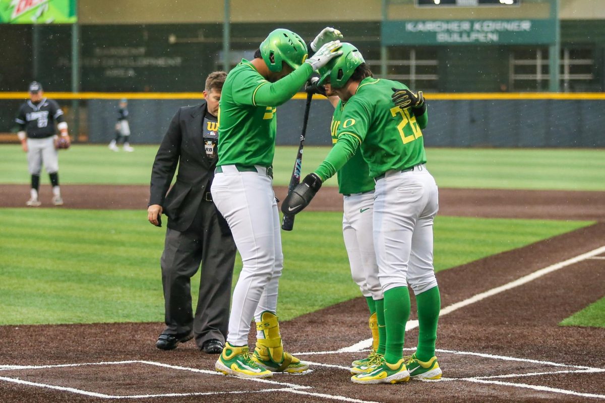 Dominic Hellman (45) celebrates with three teams while touching home. Oregon Baseball faces Grand Canyon in Eugene, Ore. on Mar. 12, 2025.