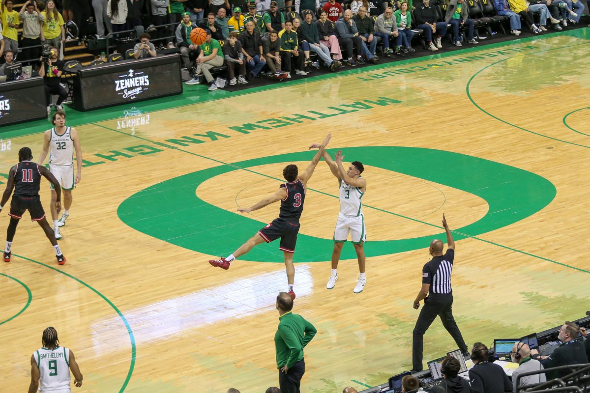 Jackson Shelstad (3) fires a deep three over an Indiana defender. Oregon Men’s Basketball takes on Indiana in Eugene, Ore. on Mar. 4, 2025.