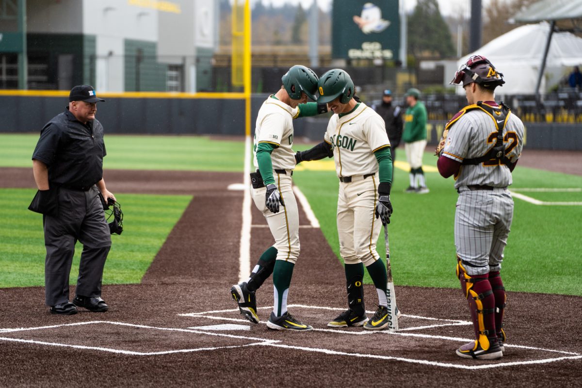 Maddox Molony (9) embraces teammate 	
Anson Aroz (77) after a run home. The University of Oregon Ducks Mens Baseball team win 5-2 in a home match against the Minnesota Gophers at PK Park in Eugene, Ore., on Mar. 14, 2025. (Rowan Campbell/Emerald).