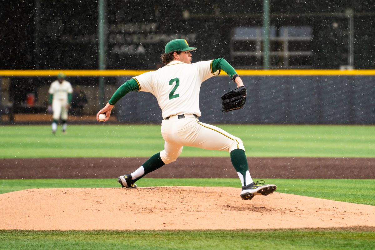 Pitcher Grayson Grinsell (2) extends while throwing in the rain. The University of Oregon Ducks Mens Baseball team win 5-2 in a home match against the Minnesota Gophers at PK Park in Eugene, Ore., on Mar. 14, 2025. (Rowan Campbell/Emerald).