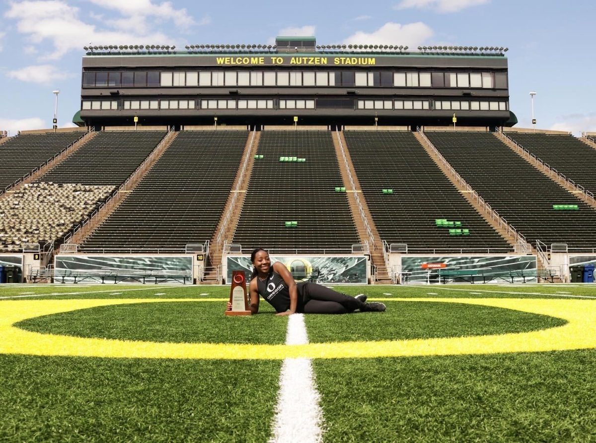 Rickelle Henderson lies at midfield at Autzen Stadium with one of her many accolades. 