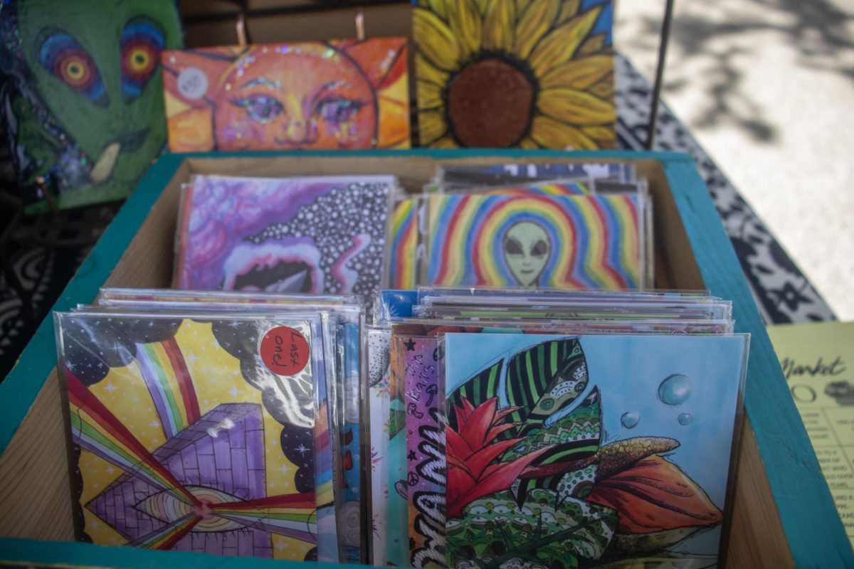 An assortment of mini prints of DeLenn Rufo’s drawings on display for sale at the Saturday Market in Eugene, Ore. (Alyssa Garcia/Emerald)   
