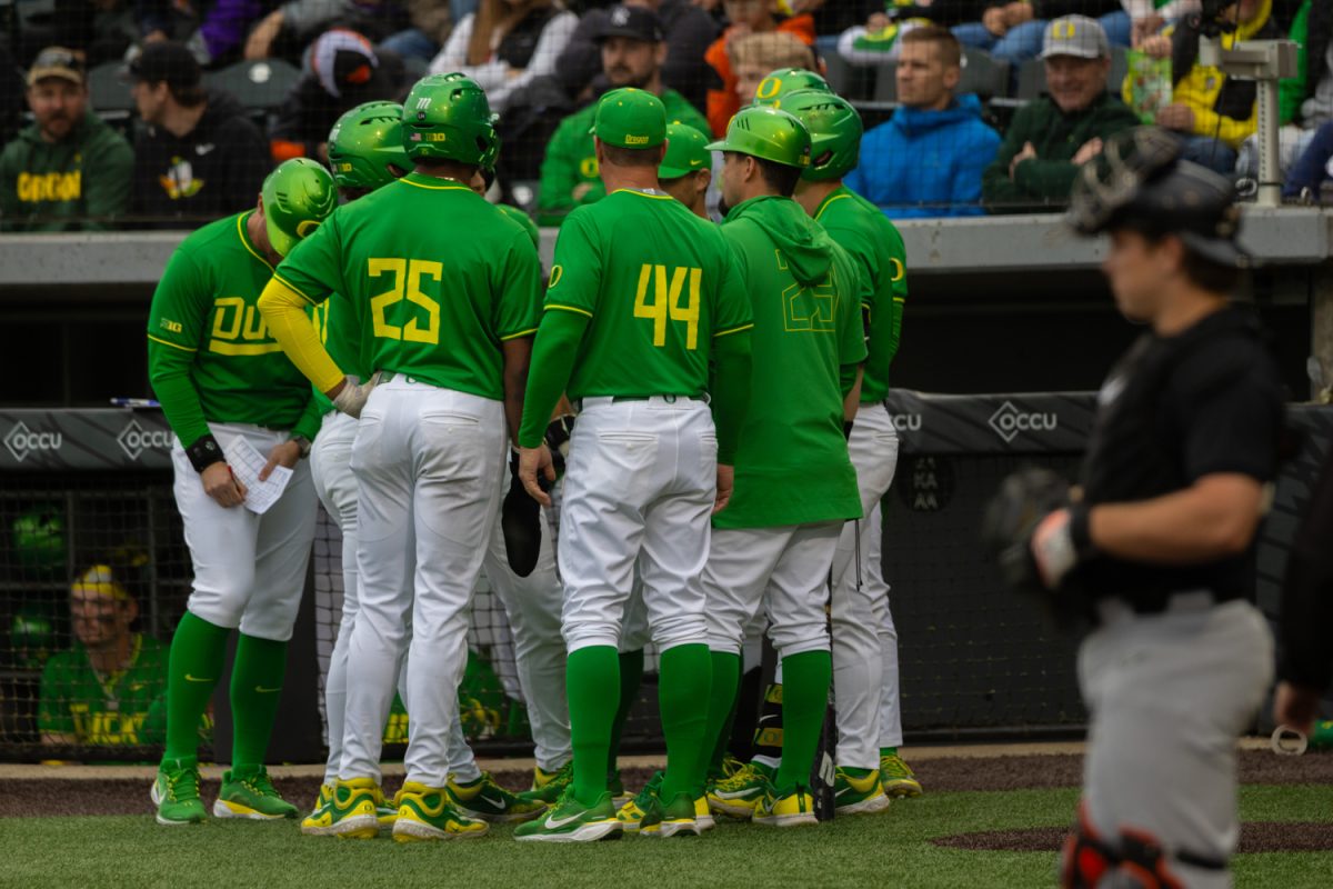 A timeout meeting for the Ducks. The Oregon Ducks hosts the Oregon State Beavers at PK Park in Eugene, Ore., on April. 25, 2025. (Julia Massa/Emerald)