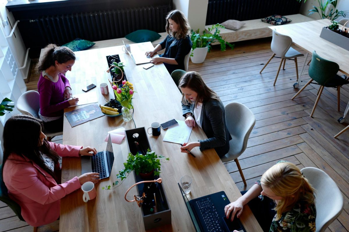 https://unsplash.com/photos/a-group-of-people-sitting-around-a-wooden-table-ZKHksse8tUU