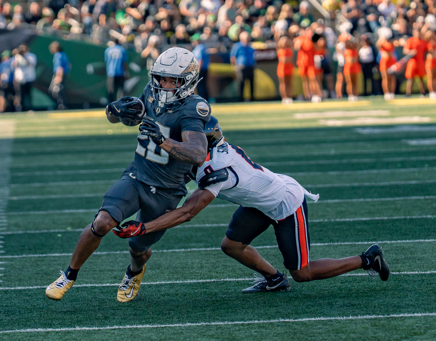 Oregon Ducks running back Makhi Hughes (20) shakes off a tackle from Oregon State Beavers defensive back Kobe Singleton (0), scoring a touchdown. On Saturday September 20th, 2025 the University of Oregon Ducks played against the Oregon State University Beavers in their 129th annual match up. At the game this year, played at Auzten Stadium in Eugene, Ore., the Ducks beat the Beavers 41-7. (Saj Sundaram/Emerald)