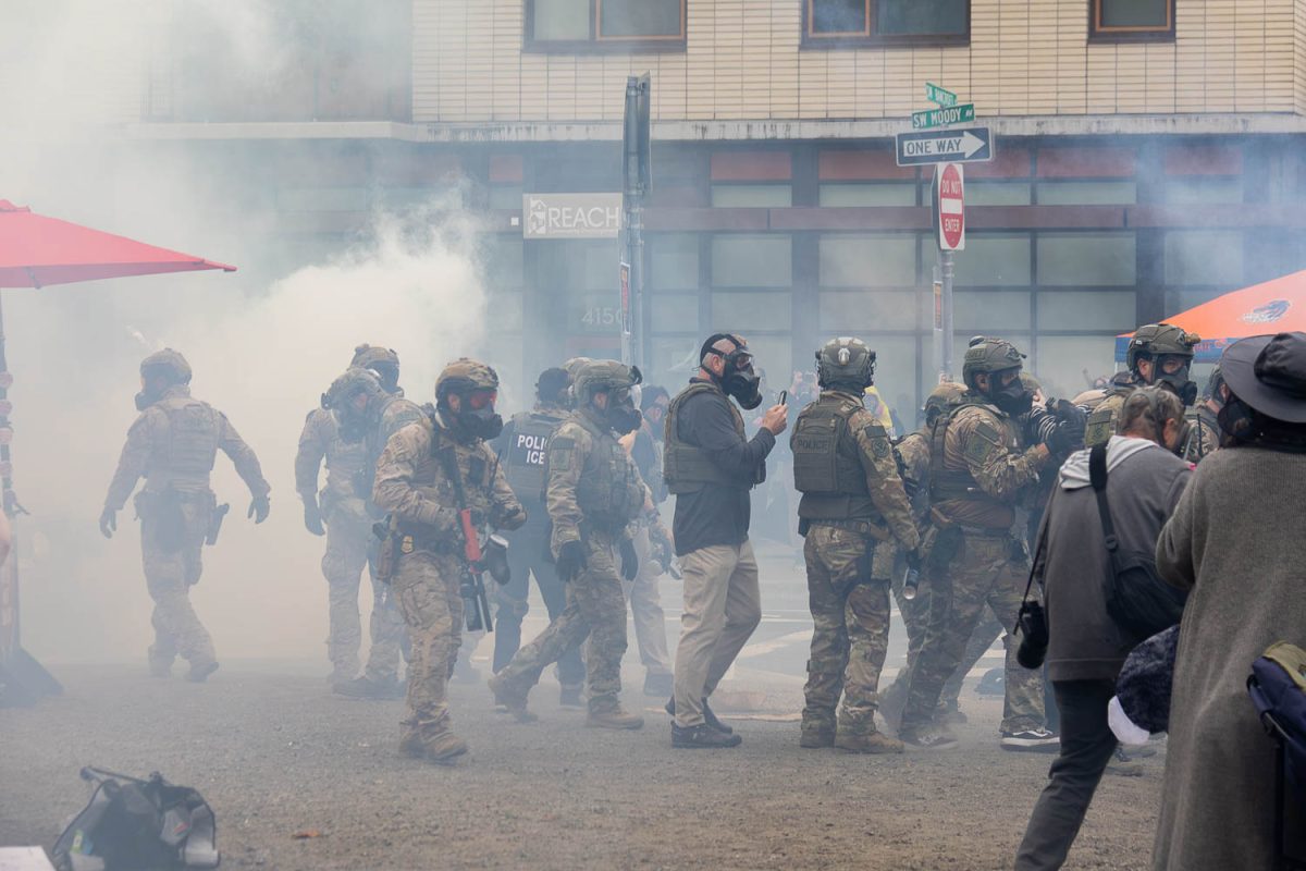 U.S. Immigrations and Customs officers disperse crowds in front of the Portland facility on Saturday Oct. 18, 2025. (Joy Edwards/Emerald)