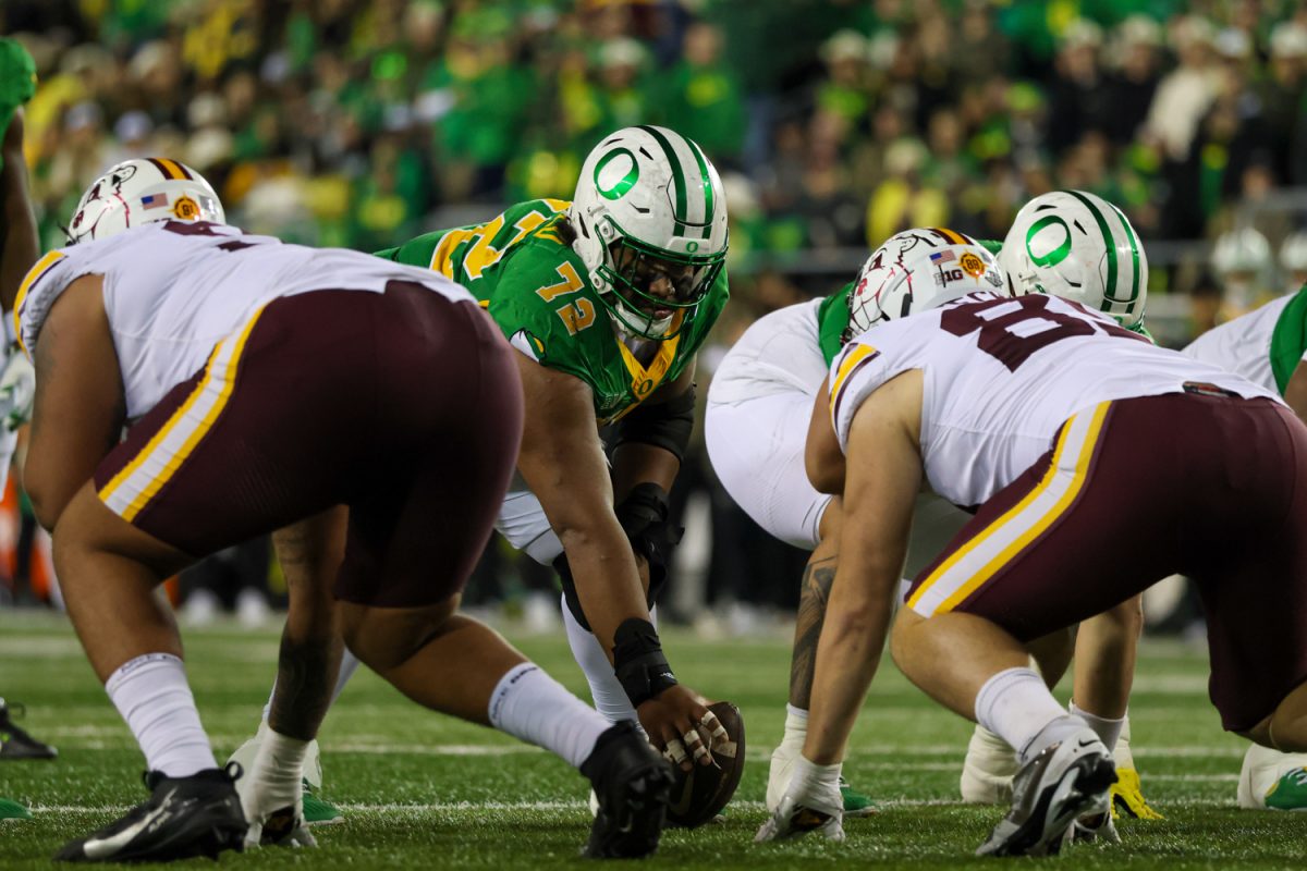 Iapani Laloulu (72), a Ducks offensive lineman, to snap the ball. The University of Oregon Ducks host the University of Minnesota Gophers in a Friday night matchup on Nov. 14, 2025, at Autzen Stadium in Eugene, Ore. (Julia Massa/Emerald)
