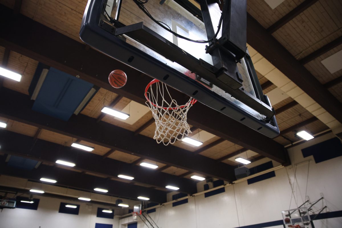 Student shoots basketball during AR competition at University of Oregon's Portland Campus. Students were able to use Snapchat Spectacles to calculate their shots, while competing for Trail Blazers tickets. (Akimba Agbohessou/Emerald)