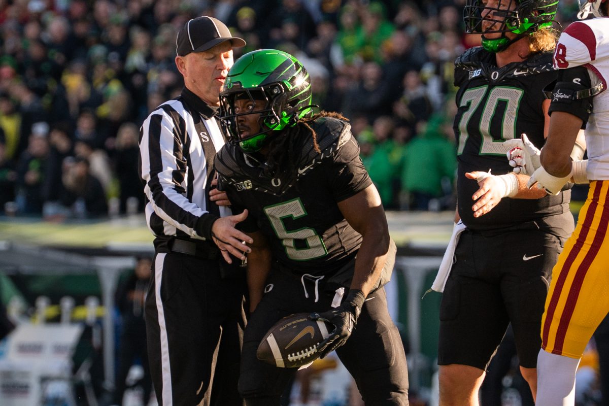 Oregon Duck running back Noah Whittington (6) runs the ball to the first down. The No. 7 University of Oregon Ducks take on West Coast rivals, the No. 15 USC Trojans in a game at Autzen Stadium in Eugene, Ore. on Nov. 22, 2025. The Ducks won the game 42-27, with tight end Kenyon Sadiq having six catches for 72 yards and running back Noah Whittington ran for 104 yards. (Katie Poluyansky/Emerald)