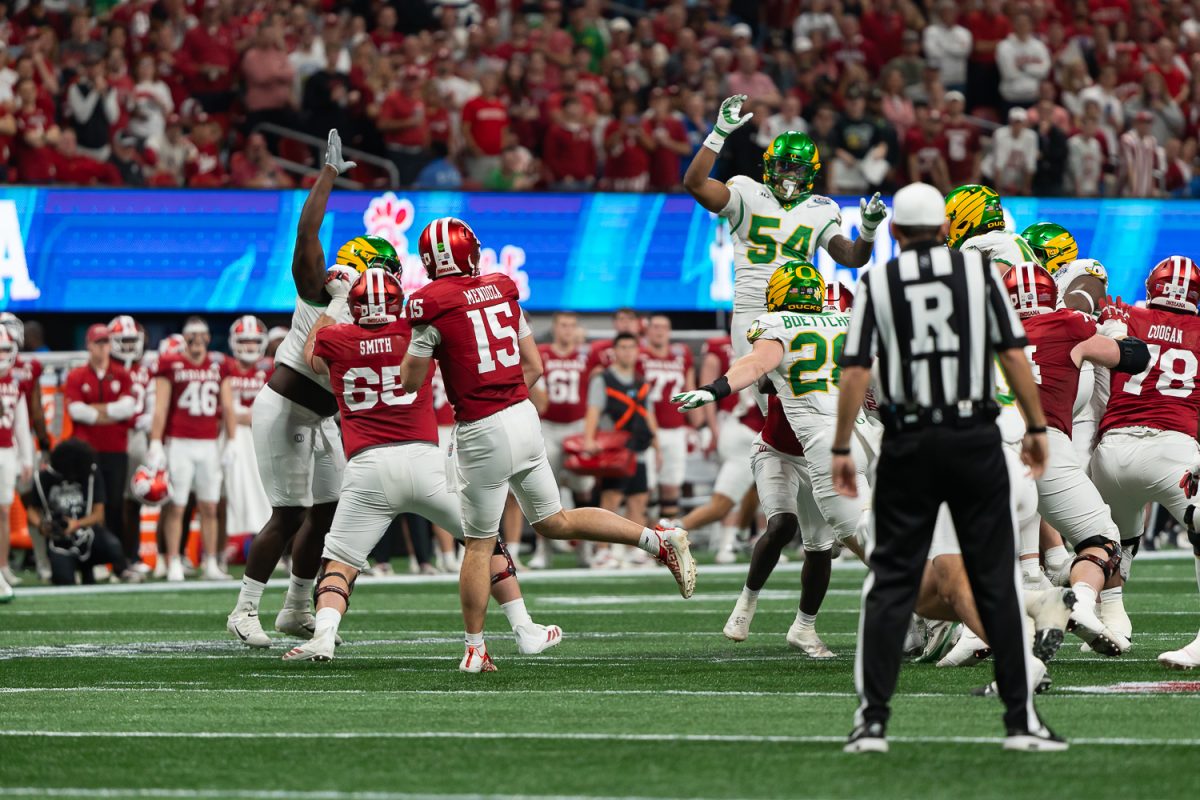 Oregon Ducks linebacker Jerry Mixon (54) jumps to attempt to block a pass from Indiana Hoosiers quarterback Fernando Mendoza (15). The No. 5 University of Oregon Ducks take on the No. 1 Indiana University Hoosiers in the third round of the College Football Playoff at the Peach Bowl held at Mercedes-Benz Stadium in Atlanta, Ga. on Jan 9, 2026. (Saj Sundaram/Emerald)