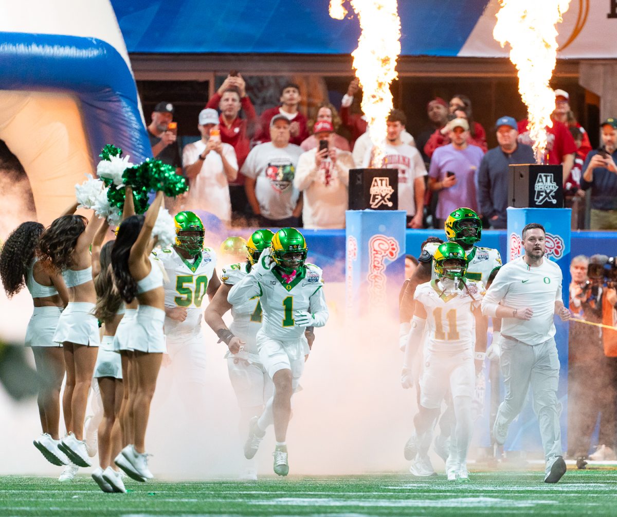 Oregon Ducks head coach Dan Lanning and the team run out of their tunnel through a plume of smoke before the start of the game. The No. 5 University of Oregon Ducks lost 22-56 to the No. 1 Indiana University Hoosiers in the third round of the College Football Playoff at the Peach Bowl held at Mercedes-Benz Stadium in Atlanta, Ga. on Jan 9, 2026. (Saj Sundaram/Emerald)