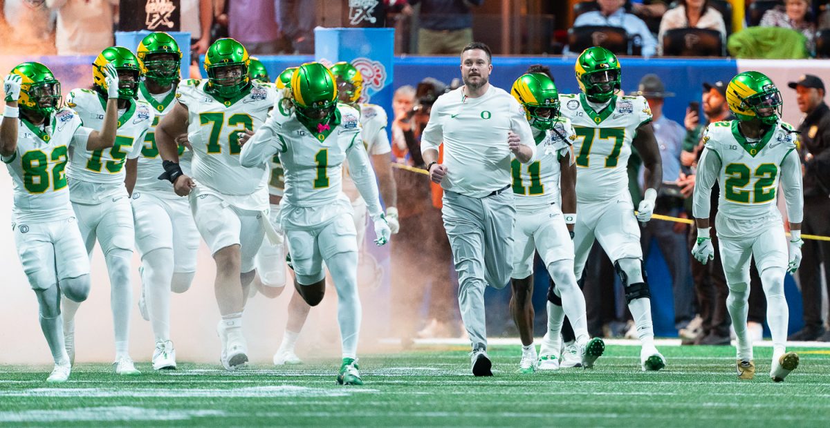 Oregon Ducks head coach Dan Lanning and the team run out of their tunnel through a plume of smoke before the start of the game. The No. 5 University of Oregon Ducks lost 22-56 to the No. 1 Indiana University Hoosiers in the third round of the College Football Playoff at the Peach Bowl held at Mercedes-Benz Stadium in Atlanta, Ga. on Jan 9, 2026. (Saj Sundaram/Emerald)