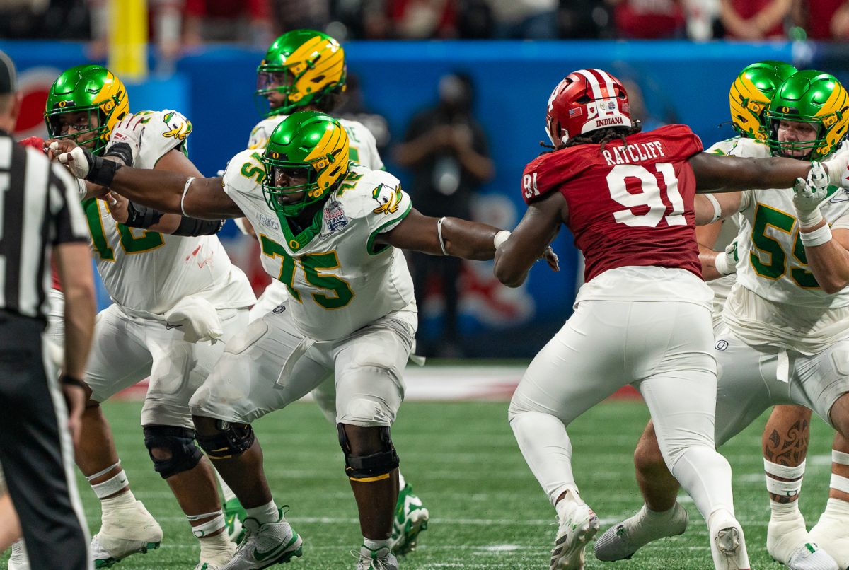 Oregon Ducks offensive lineman Kawika Rogers (73) sprints to the left while Oregon Ducks offensive lineman Emmanuel Pregnon (75) moves to the right to block the Indiana defensive line for Oregon Ducks quarterback Dante Moore (5). The No. 5 University of Oregon Ducks lost 22-56 to the No. 1 Indiana University Hoosiers in the third round of the College Football Playoff at the Peach Bowl held at Mercedes-Benz Stadium in Atlanta, Ga. on Jan 9, 2026. (Saj Sundaram/Emerald)