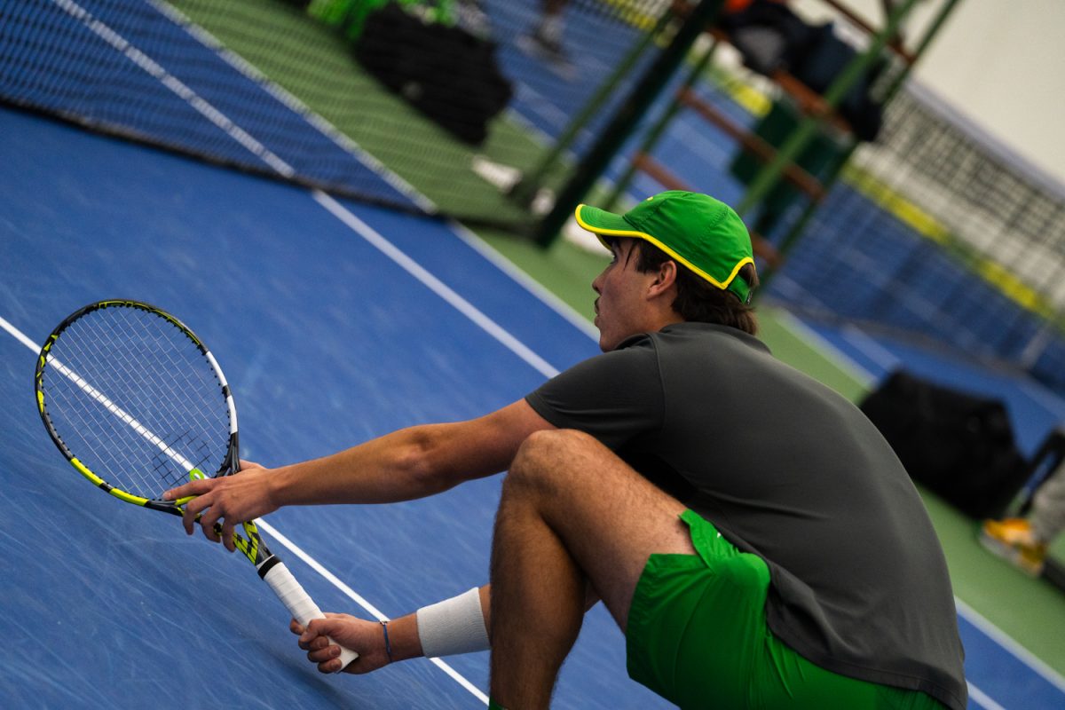 University of Oregon senior Pierre Mouesca gets low and prepares for the opponents to return his teammates serve. On Janurary 17, 2026, the University of Oregon's men's tennis team played against the University of Portland in the student tennis center in Eugene, Ore. (Katie Poluyansky/Emerald)