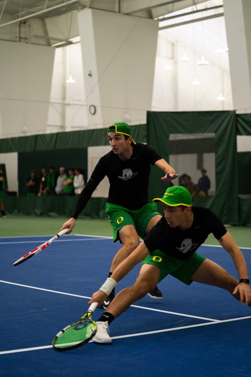 Freshman Declan Galligan and his teammate senior Lachlan Robertson both attempt to go for the ball. On Janurary 17, 2026, the University of Oregon's men's tennis team played against the University of Portland in the student tennis center in Eugene, Ore. (Katie Poluyansky/Emerald)