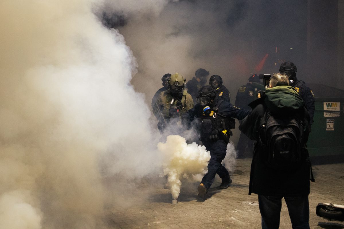 A federal agent kicks a tear gas canister into the crowd of protesters at the Portland ICE facility on Jan. 24, 2026 (Mikayla Mesko/Emerald)