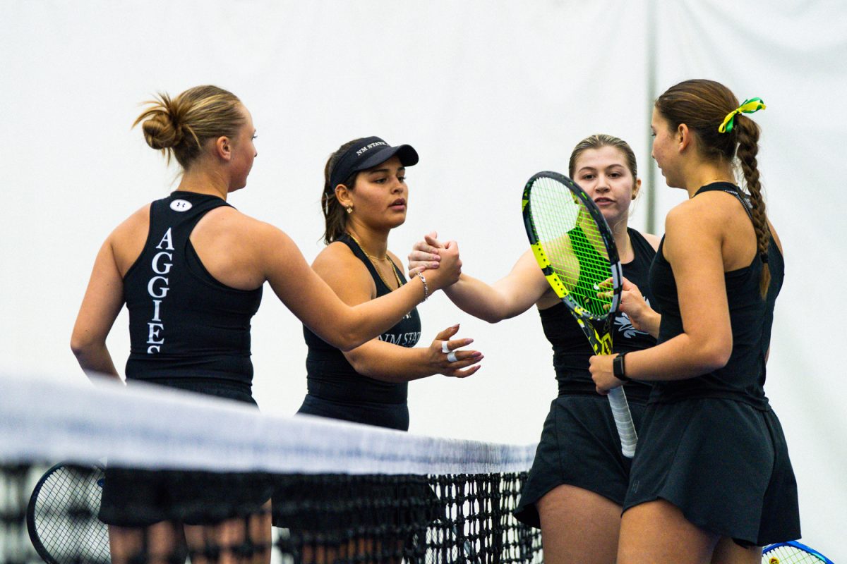 Oregon freshman Hadley Appling and teammate Virginia Crocker shake hands post match with NMSU players Nadia Nemeth and Anna Klimova. The University of Oregon Ducks Women’s Tennis team win 4-0 in a home match against the New Mexico State University Aggies in Eugene, Ore., on Jan. 24, 2026. (Rowan Campbell/Emerald).