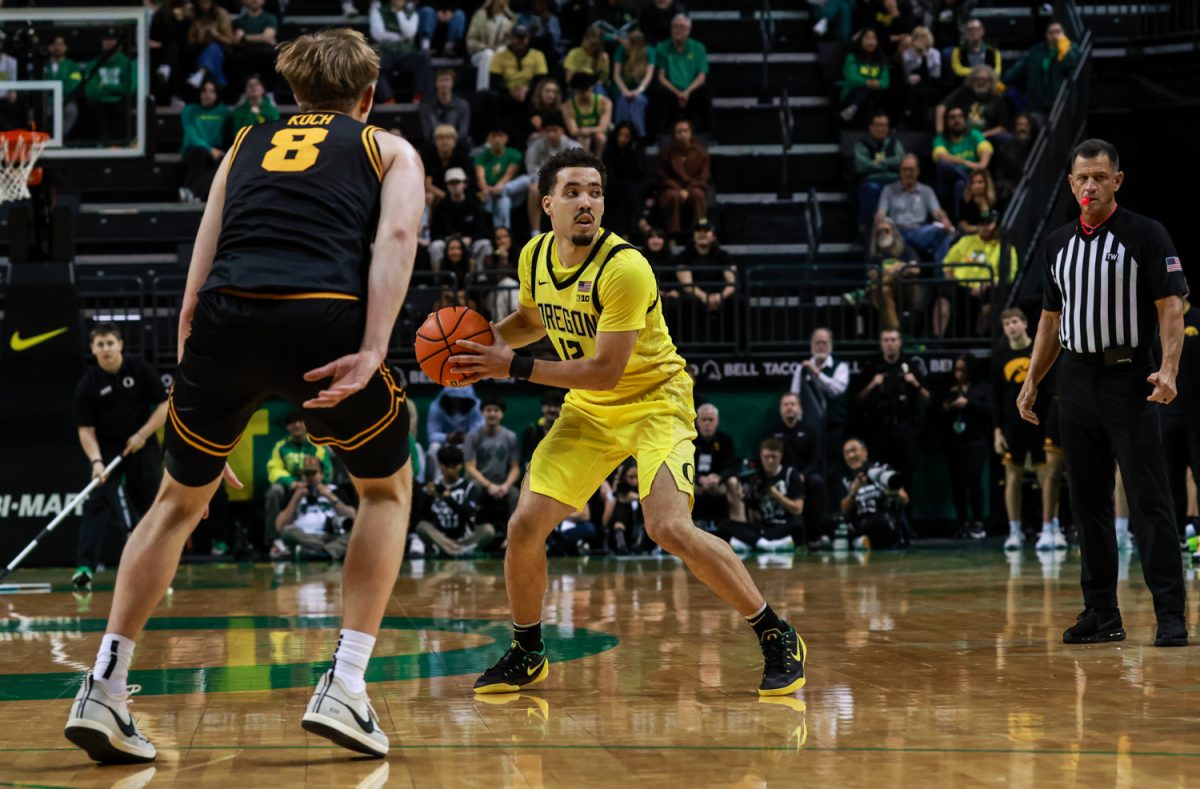 Senior gaurd for the Ducks, Drew Carter (12), swings the ball as he moves up the court. On February 1, 2026, the Oregon Ducks hosted the Iowa Hawkeyes at Matthew Knight Arena in Eugene, Ore. (Julia Massa/Emerald)