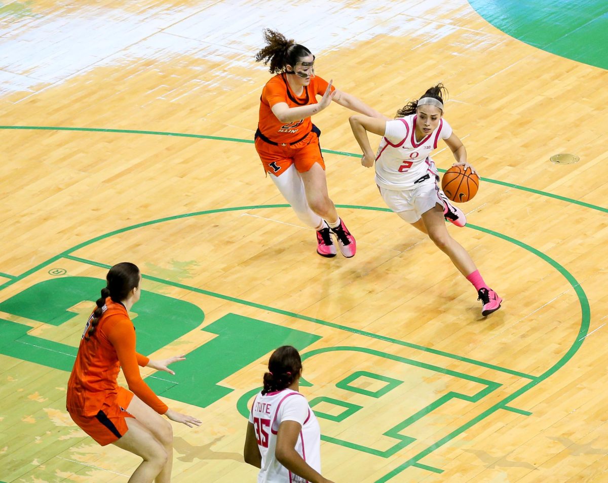 Oregon guard Katie Fiso (2) drives past an Illinois player. Oregon Ducks Women’s Basketball take on the Illinois Fighting Illini at Matthew Knight Arena in Eugene, Ore., on Feb. 4, 2026. (Tyler Graham/Emerald)