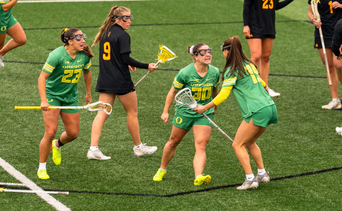 Senior midfielder Anna Simmons (30 celebrates a goal with her teammates. On Feb. 7th, 2026 the University of Oregon women's lacrosse team hosted a season-opening game against Arizona State University on Papé Field in Eugene, Ore. (Katie Poluyansky/Emerald)