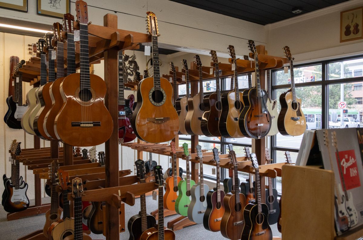 A range of guitar types hang on display throughout Buy & Sell Center on Feb. 17, 2026. Buy & Sell Center is located at 410 E 11th Ave in Eugene, Ore. (Julia Massa/Emerald)