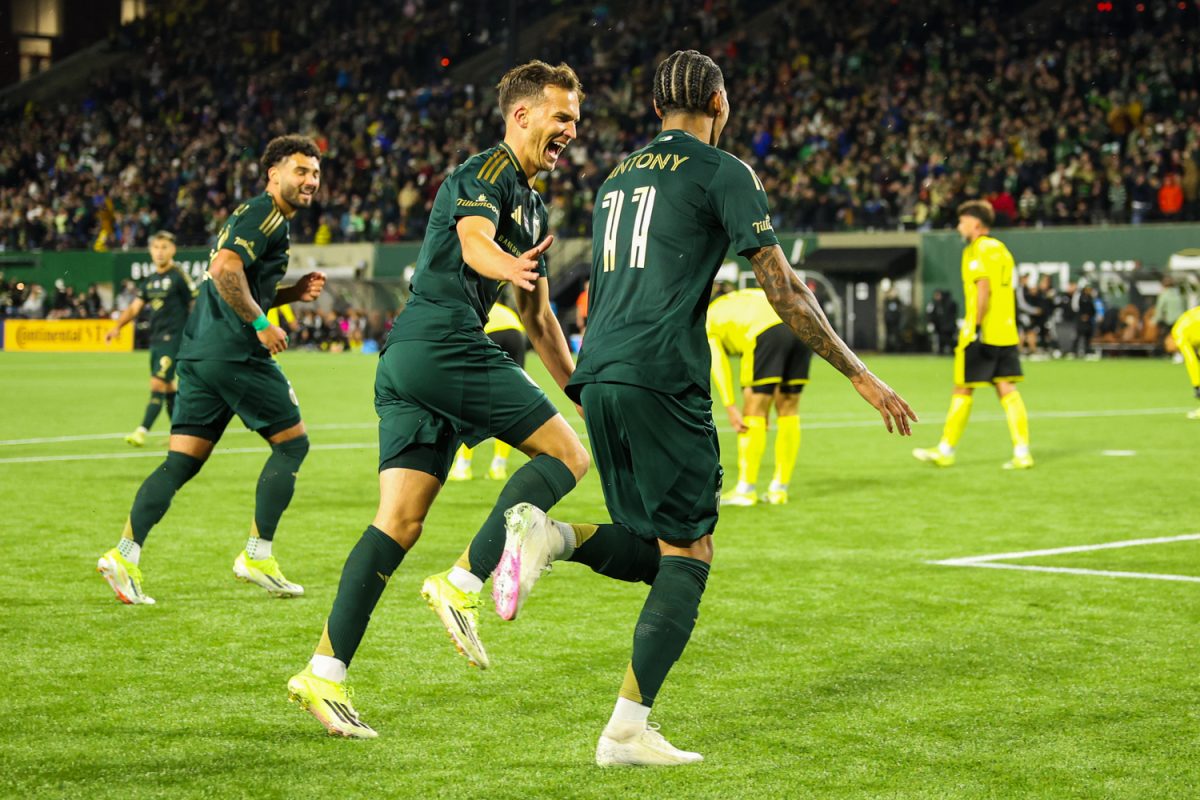 Midfielder Cole Basset and Forward Antony celebrate after the Portland Timbers score against the Columbus Crew. (Akimba Agbohessou/Emerald)