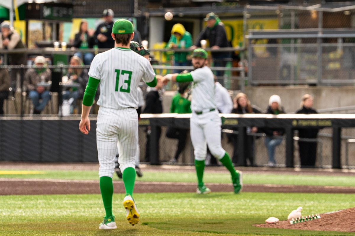 Duck first baseman Gabe Miranda (26) tosses the ball back to pitcher Miles Gosztola (13). On Feb. 21 2026, University of Oregon men's baseball team took on Youngstown State Penguins for the third game in the series at PK Park in Eugene, Ore. (Katie Poluyansky/Emerald)