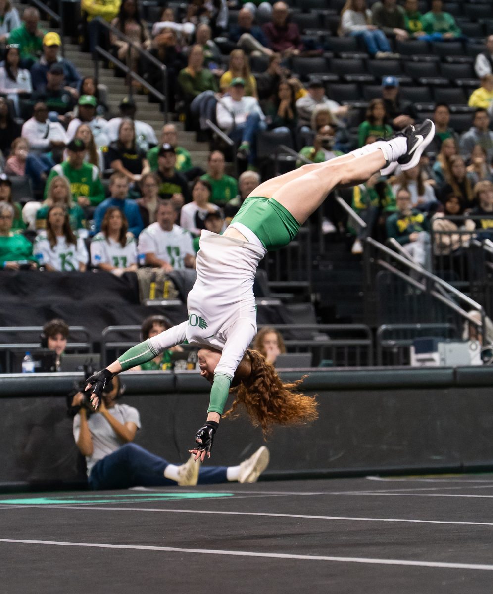 Top/tumbler Briya Alvardo (25) backflips through the air during the tumbling event. The Oregon Acro and Tumbling team took on the No. 3 Quinnipiac University at Matthew Knight Arena in Eugene, Ore. on Feb 21, 2025, winning 270.640 to 265.425. (Saj Sundaram/Emerald)