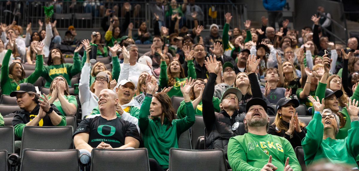 Families of the Oregon Acro and Tumbling team put their hands up for "Shout", and Oregon tradition, being played after the end of the match. The Oregon Acro and Tumbling team perform their routine during the team event. The Oregon Acro and Tumbling team took on the No. 3 Quinnipiac University at Matthew Knight Arena in Eugene, Ore. on Feb 21, 2025, winning 270.640 to 265.425. (Saj Sundaram/Emerald)