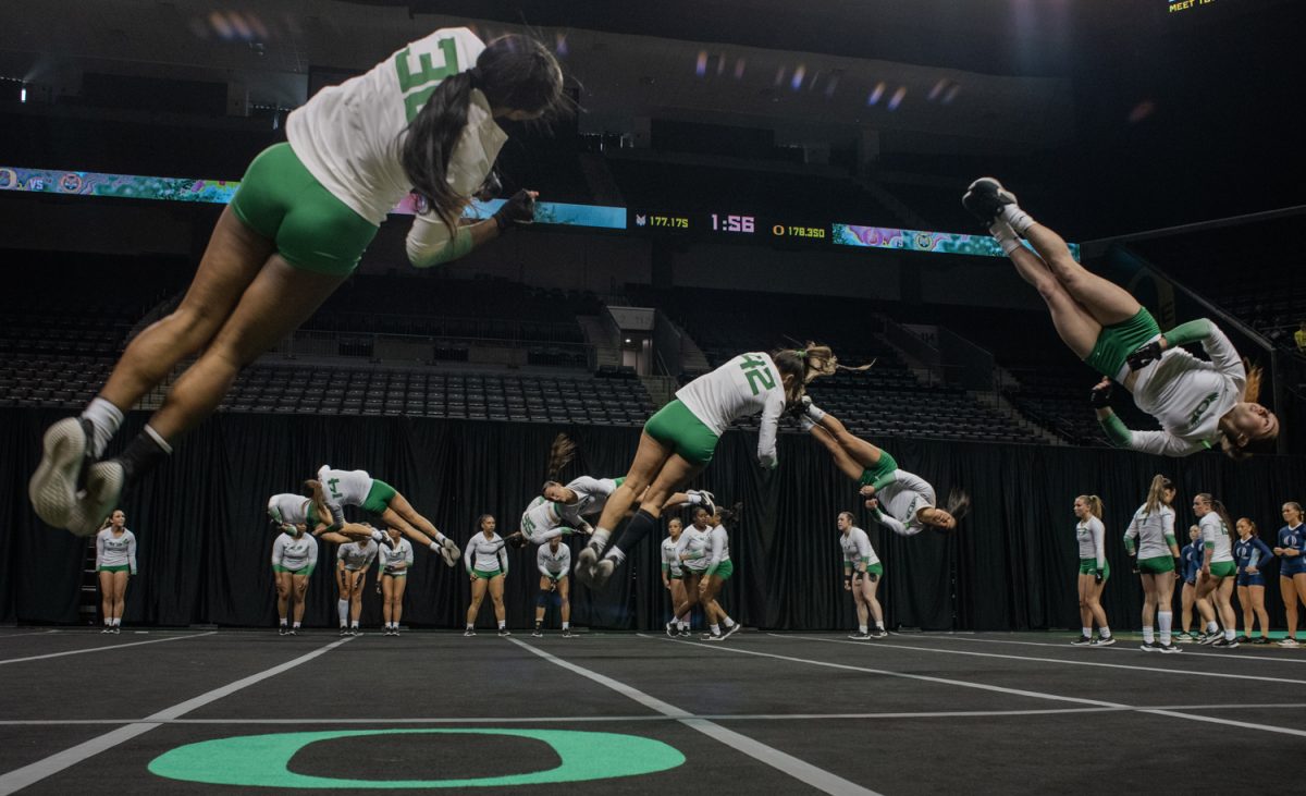 Oregon athletes do flips during the team event at the end of their meet vs Quinnipiac. The Oregon Acro and Tumbling team takes on Quinnipiac University at Matthew Knight Arena in Eugene, Ore. on Feb 21, 2025. (Chris Castro/Emerald)