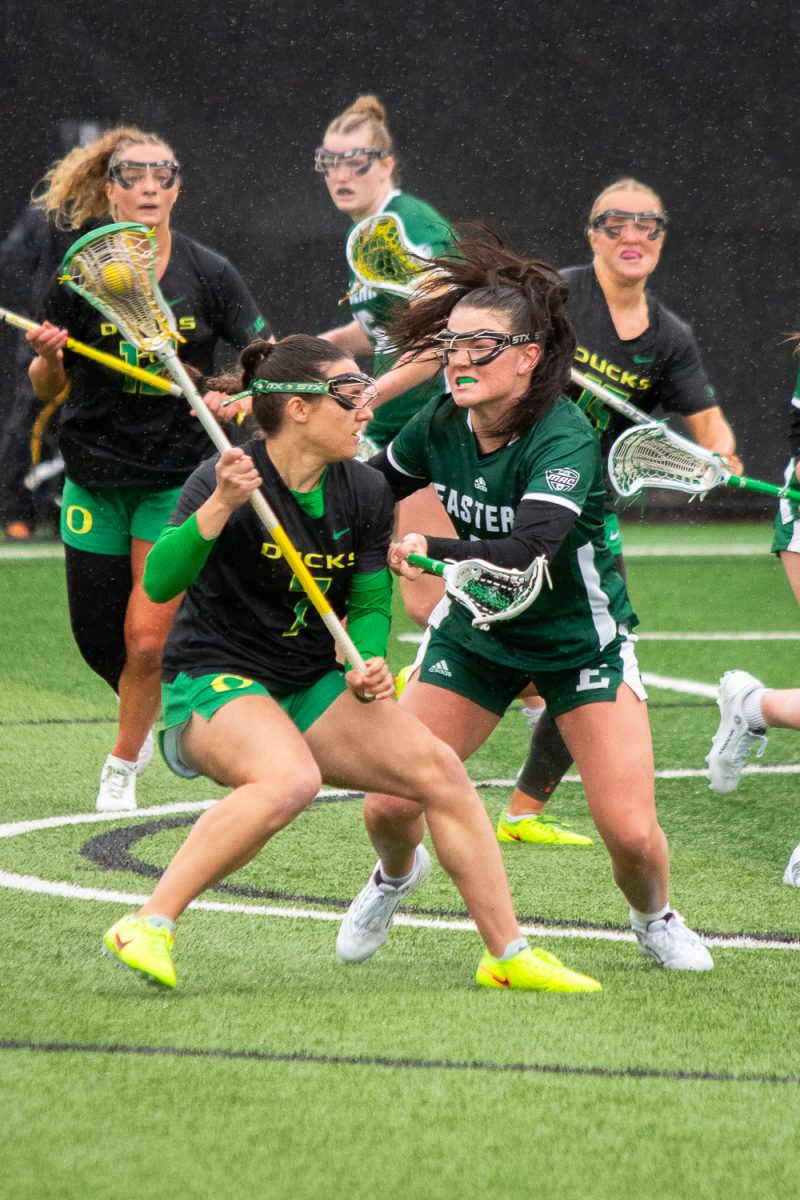 Oregon middle Liv Kozitza (7) gets fiercely guarded by Eastern Michigan defender Karly Low (39)  On February 22, 2026, the University of Oregon Ducks took a close loss to the Eastern Michigan University Eagles at Papé Field, at University of Oregon, based in Eugene, Ore. (Fred Hall/Emerald)