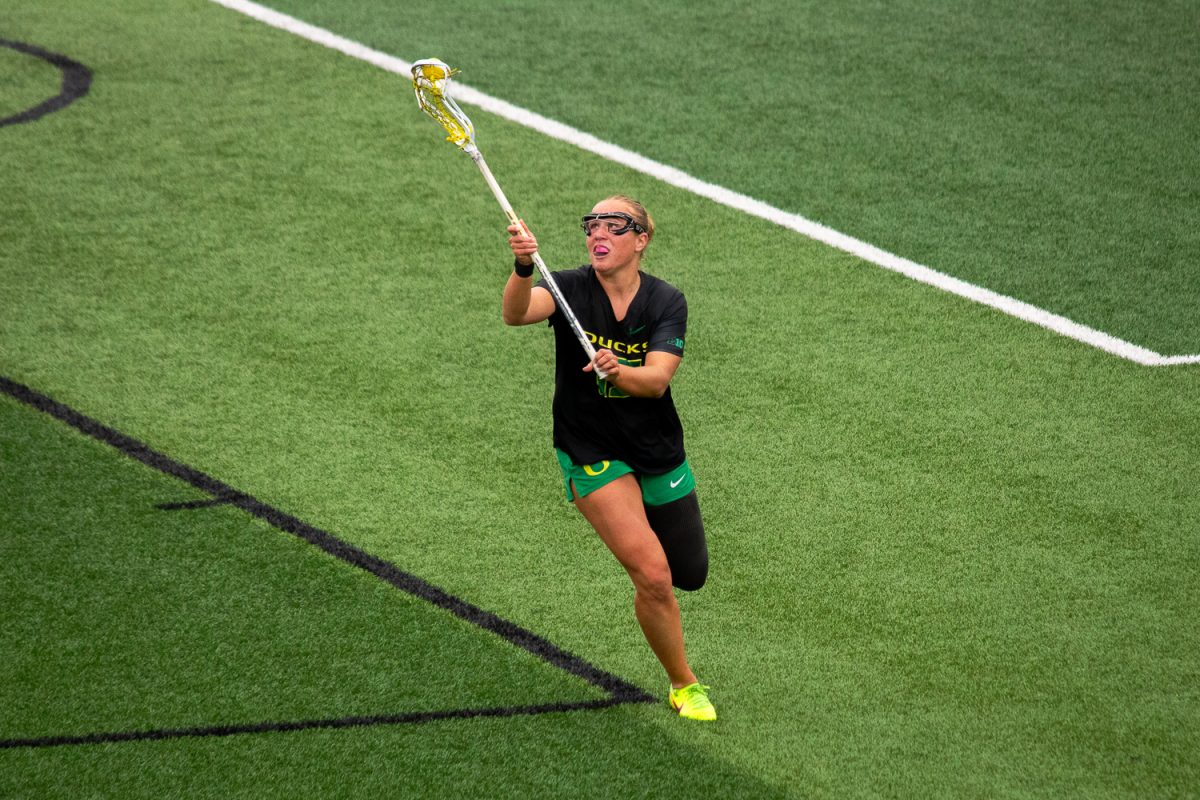 Oregon attacker Avery Young (15) scoops up the ball as she takes it up the field. On February 22, 2026, the University of Oregon Ducks took a close loss to the Eastern Michigan University Eagles at Papé Field, at University of Oregon, based in Eugene, Ore. (Fred Hall/Emerald)