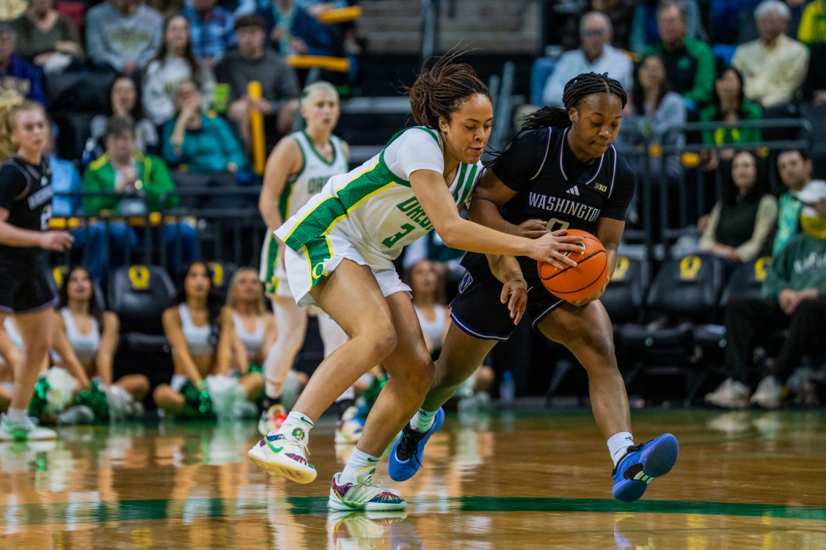 Oregon guard Sofia Bell (3) fights Washington forward Daniella McLean (8) for the ball. The University of Oregon Ducks Women’s Basketball team lose against the University of Washington Huskies 69-70 at Matthew Knight Arena in Eugene, Ore., on Mar. 1, 2026. (Rowan Campbell/Emerald).