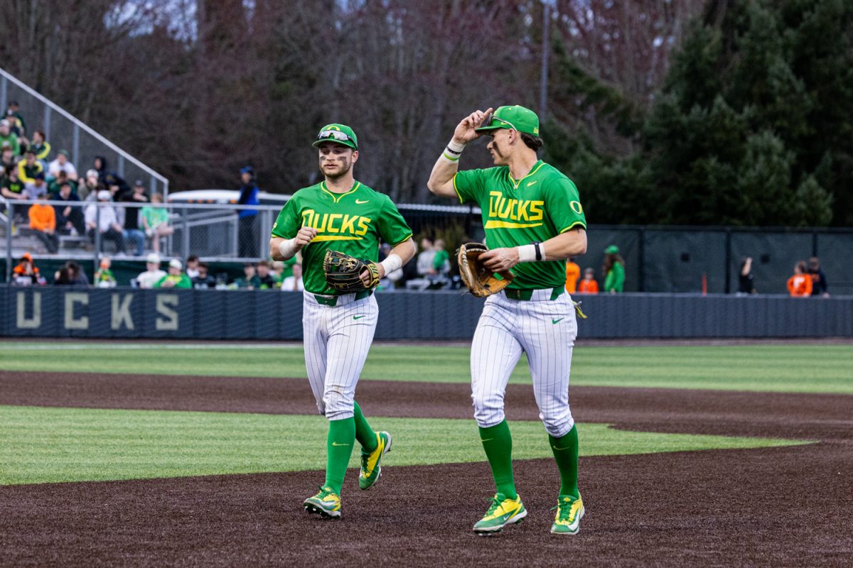 Duck middle infielders Ryan Cooney (12) and Maddox Molony (9) jog back to the dugout. Oregon Duck baseball hosted in-state rivals the Oregon State Beavers at PK Park in Eugene, Ore. on March 3, 2026, losing 10-6. (Owen Burriss/Emerald)