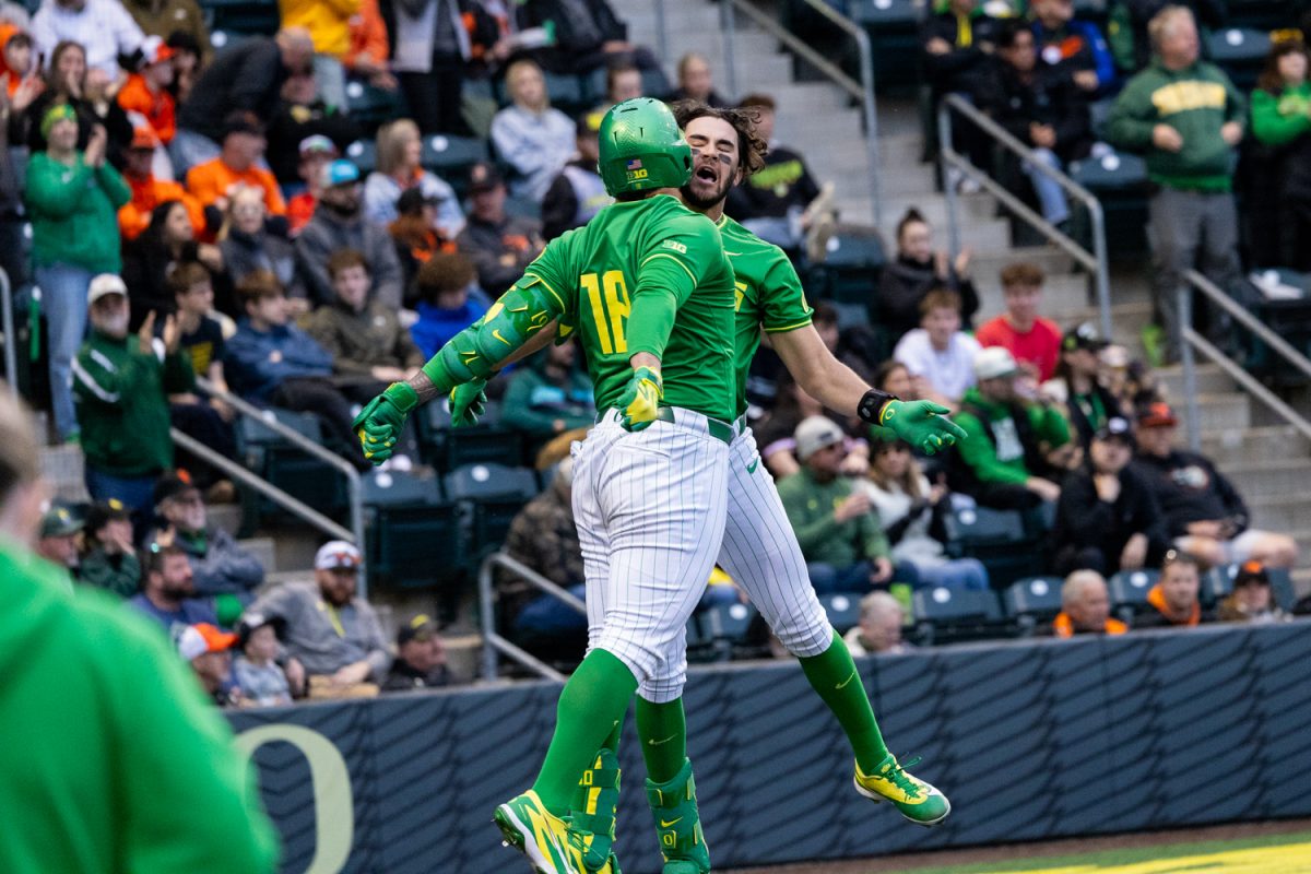 Oregon teammates Naulivou Lauaki Jr. (18) and Angel Laya (53) chest‑bump after Laya’s home run. Oregon Duck baseball hosted in-state rivals the Oregon State Beavers at PK Park in Eugene, Ore. on March 3, 2026, losing 10-6. (Owen Burriss/Emerald)