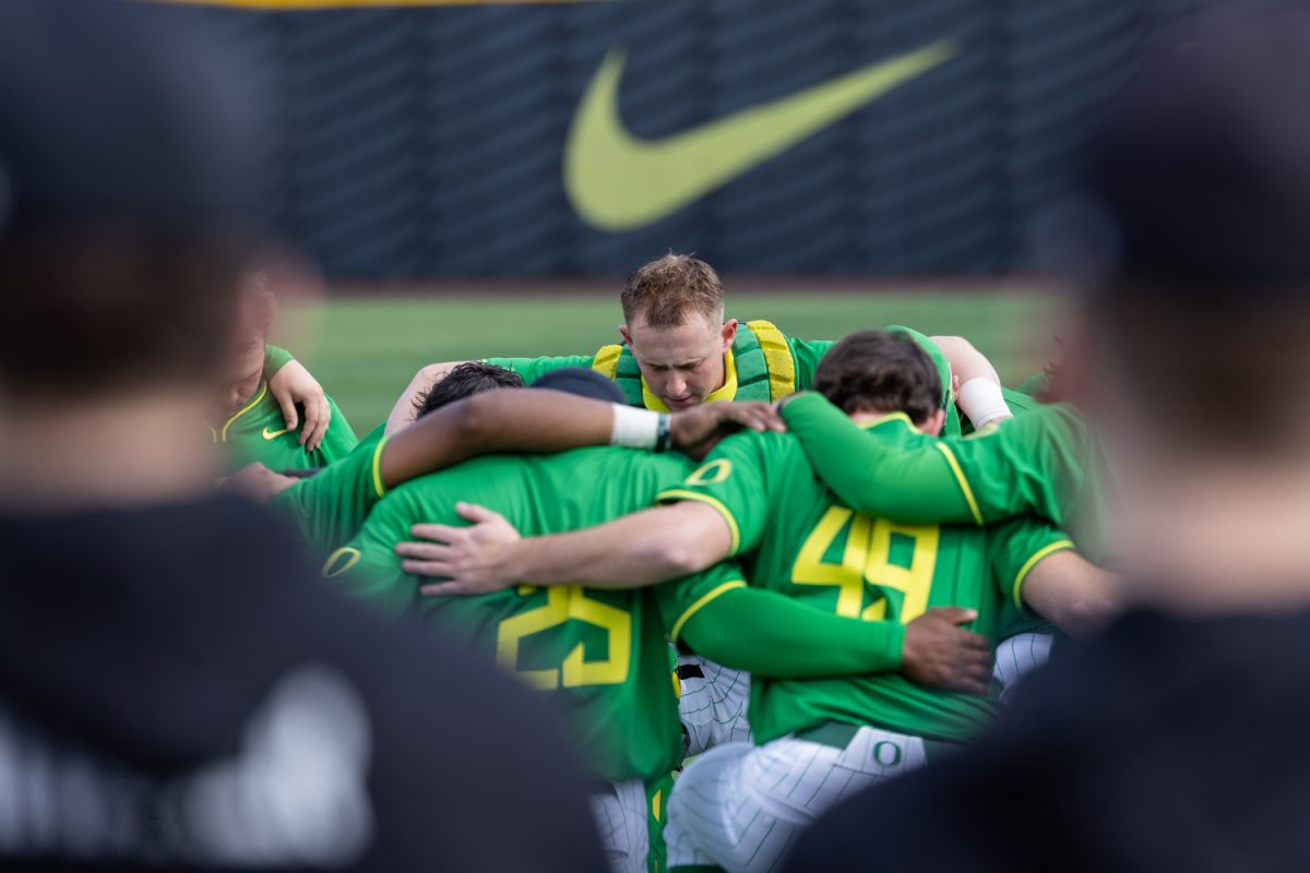 Ducks players huddle for a pregame prayer. Oregon Duck baseball hosted in-state rivals the Oregon State Beavers at PK Park in Eugene, Ore. on March 3, 2026, losing 10-6. (Owen Burriss/Emerald)