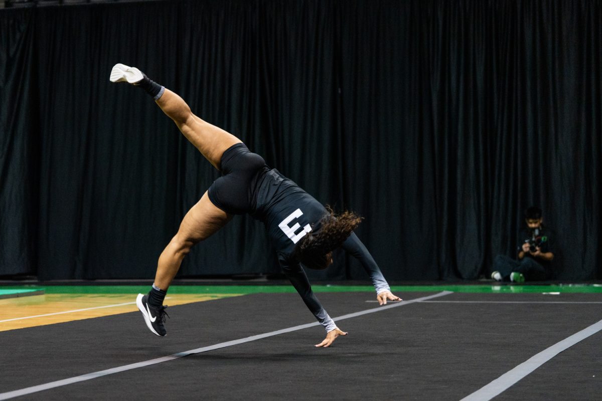 Oregon tumbler Nya Womack (3) extends for a lift. University of Oregon Ducks Women’s Acrobatics and Tumbling team in battle a home match against Gannon University at Matthew Knight Arena in Eugene, Ore., on Mar. 6, 2026. (Rowan Campbell/Emerald).