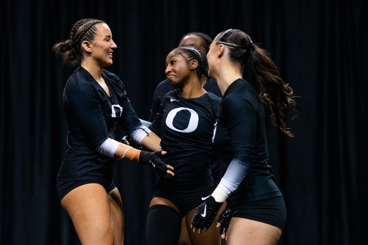 Oregon base Ashlyn Parlett (11) celebrates with top Selah Bell (23) after completing the routine. University of Oregon Ducks Women’s Acrobatics and Tumbling team battle in a home match against Gannon University at Matthew Knight Arena in Eugene, Ore., on Mar. 6, 2026. (Rowan Campbell/Emerald).