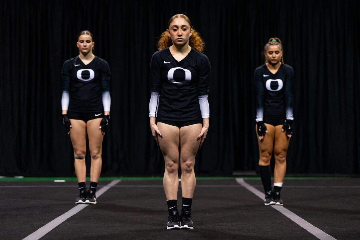 Oregon top Briya Alvarado (25) stands at attention as she waits for the start of the routine. University of Oregon Ducks Women’s Acrobatics and Tumbling team battle in a home match against Gannon University at Matthew Knight Arena in Eugene, Ore., on Mar. 6, 2026. (Rowan Campbell/Emerald).