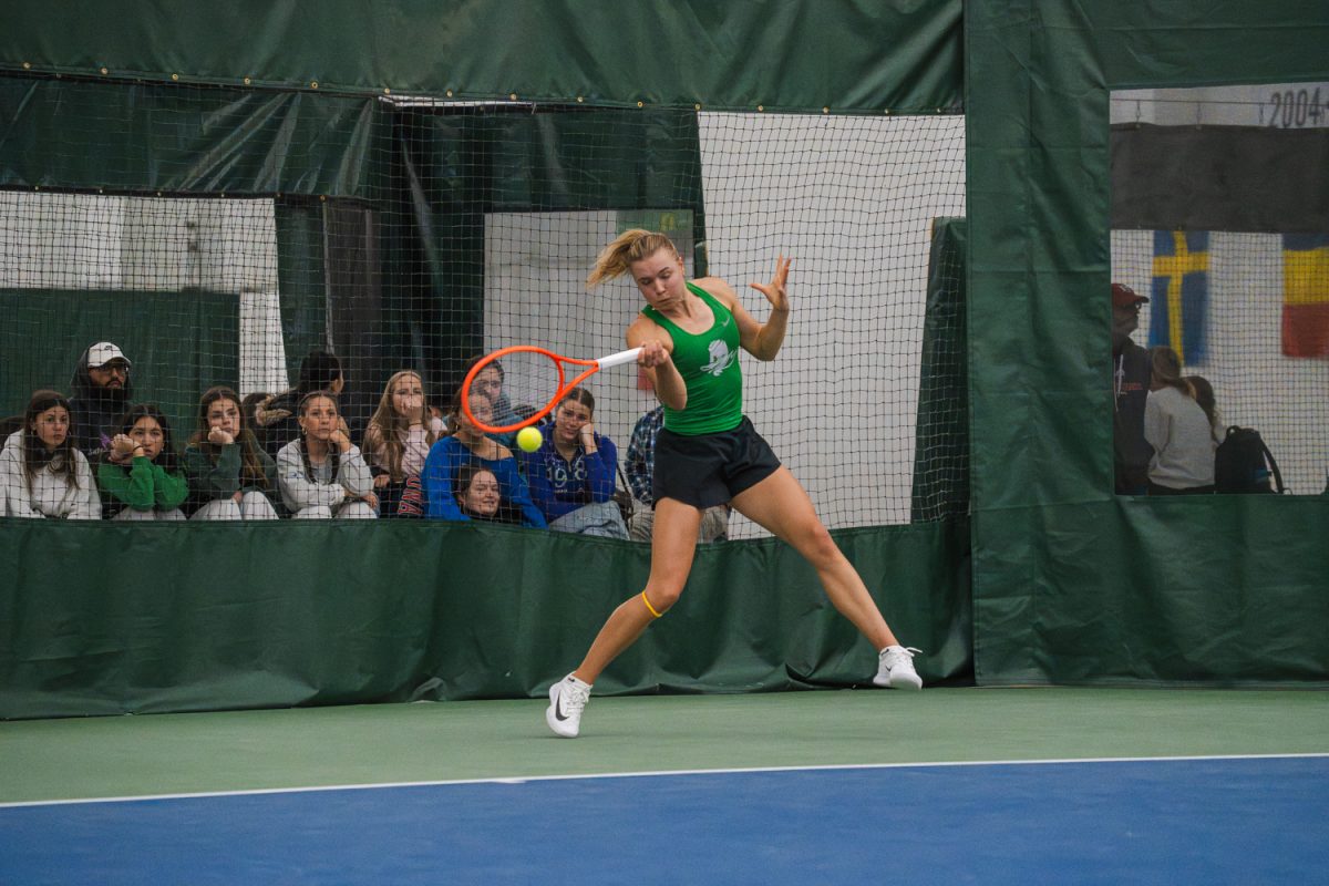 Junior Tilde Jagare shifts her weight to strike the ball. The University of Oregon Women’s tennis team defeated Rutgers University 4-0 on March 8, 2026, in Eugene, Ore at the Student Tennis Center. (Lilly Wall/Emerald)